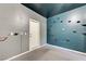 Basement featuring blue and gray walls and door leading outside at 6533 Sundown Heights Ave, Las Vegas, NV 89130
