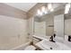 Bathroom features a tub, toilet, and sink with large mirror at 6533 Sundown Heights Ave, Las Vegas, NV 89130