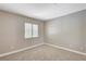 Bedroom with neutral colored walls and carpet, and window with white shutters at 6533 Sundown Heights Ave, Las Vegas, NV 89130