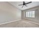 Spacious carpeted bedroom with a ceiling fan and a window with plantation shutters at 6533 Sundown Heights Ave, Las Vegas, NV 89130