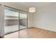Bedroom features a large sliding glass door, neutral paint and wood-look flooring at 6533 Sundown Heights Ave, Las Vegas, NV 89130