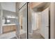 Hallway with mirrored closet doors and access to a bathroom with a wood vanity at 6533 Sundown Heights Ave, Las Vegas, NV 89130