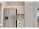 Well-organized kitchen space featuring a stainless steel refrigerator and white cabinetry at 6533 Sundown Heights Ave, Las Vegas, NV 89130