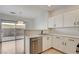 Bright kitchen with stainless steel dishwasher, light countertops, and sliding glass doors at 6533 Sundown Heights Ave, Las Vegas, NV 89130