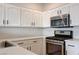Bright kitchen features white cabinets, modern appliances, and ample counter space at 6533 Sundown Heights Ave, Las Vegas, NV 89130