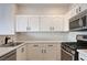 Modern kitchen featuring white cabinets, stainless steel appliances, and sleek countertops at 6533 Sundown Heights Ave, Las Vegas, NV 89130