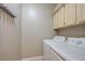 Laundry room with washer, dryer and cabinets above at 6533 Sundown Heights Ave, Las Vegas, NV 89130