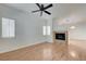 Bright living room features wood-look flooring, a ceiling fan, and a cozy fireplace at 6533 Sundown Heights Ave, Las Vegas, NV 89130