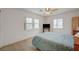 Bedroom featuring three windows, ceiling fan and light neutral carpet at 775 Wigan Pier Dr, Henderson, NV 89002