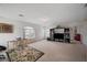 Spacious carpeted bonus room with large windows and entertainment center at 775 Wigan Pier Dr, Henderson, NV 89002