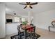 Cozy dining area with dark wood table, opening into the living room, great for entertaining and Gathering meals at 775 Wigan Pier Dr, Henderson, NV 89002