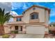 Inviting two-story home with a well-manicured front yard and attached two-car garage at 775 Wigan Pier Dr, Henderson, NV 89002