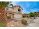 Charming two-story home with a well-manicured front yard and an attached two-car garage at 775 Wigan Pier Dr, Henderson, NV 89002