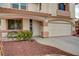 Attractive home featuring a manicured front yard, two-car garage, and inviting entrance at 775 Wigan Pier Dr, Henderson, NV 89002