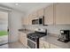 Kitchen showcases stainless steel range and microwave with light wood cabinets at 775 Wigan Pier Dr, Henderson, NV 89002