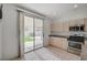 Charming kitchen with stainless steel appliances and a sliding glass door to the backyard at 775 Wigan Pier Dr, Henderson, NV 89002