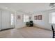 Bright and airy living room featuring neutral paint, carpet flooring, and ample natural light at 775 Wigan Pier Dr, Henderson, NV 89002