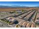 Overhead view showcasing a well-planned community, nearby commercial area, and the scenic mountain backdrop at 7853 Bethel Heights Ln, Las Vegas, NV 89113