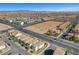 Aerial view highlighting the community layout, roadways, and proximity to open desert space under a clear blue sky at 7853 Bethel Heights Ln, Las Vegas, NV 89113