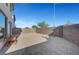 Wide angle picture of gravel backyard with brick perimeter, some greenery, and wood chair at 7853 Bethel Heights Ln, Las Vegas, NV 89113