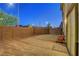 Backyard with cinder block wall, gravel, and wooden chairs outside sliding glass door at 7853 Bethel Heights Ln, Las Vegas, NV 89113