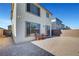 Spacious gravel backyard with neutral stucco home, modern windows, and contemporary lighting at 7853 Bethel Heights Ln, Las Vegas, NV 89113