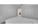 This bedroom includes neutral walls and carpet with an entrance to another room and double door closet at 7853 Bethel Heights Ln, Las Vegas, NV 89113
