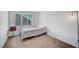 This bedroom has neutral walls, carpet, a window with blinds and a decorative lamp at 7853 Bethel Heights Ln, Las Vegas, NV 89113