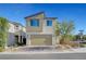 Modern two-story home with a two-car garage, desert landscaping, and a brick driveway on a sunny day at 7853 Bethel Heights Ln, Las Vegas, NV 89113