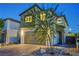 Two story home with a two-car garage, desert landscaping, and well manicured rock groundcover at 7853 Bethel Heights Ln, Las Vegas, NV 89113