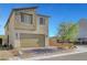 Two-story modern home with a two-car garage, minimalist landscaping, and a brick driveway under a clear sky at 7853 Bethel Heights Ln, Las Vegas, NV 89113