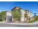 Contemporary two-story home features neutral stucco, desert landscaping, and a two-car garage on a sunny day at 7853 Bethel Heights Ln, Las Vegas, NV 89113