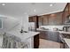 Modern kitchen features a large island with seating, stainless steel appliances, and stylish dark wood cabinets at 7853 Bethel Heights Ln, Las Vegas, NV 89113