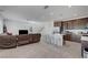 Open-concept living area combining a living room with a kitchen island, offering space and modern living at 7853 Bethel Heights Ln, Las Vegas, NV 89113