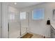 Bathroom featuring glass enclosed shower, seat, and a window at 7853 Bethel Heights Ln, Las Vegas, NV 89113