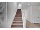 Carpeted staircase with white railing, leading to the upper level of the home at 7853 Bethel Heights Ln, Las Vegas, NV 89113