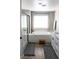 Bright bathroom featuring a soaking tub, modern fixtures, and wood-style flooring at 8186 Guadiano Ave, Las Vegas, NV 89113