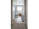 Bright bathroom featuring a soaking tub, modern fixtures, and wood-style flooring at 8186 Guadiano Ave, Las Vegas, NV 89113