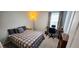 Cozy bedroom with a comfortable bed, desk, and ample natural light at 8186 Guadiano Ave, Las Vegas, NV 89113