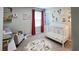 Cozy Bedroom with crib, rocker, and animal-themed decor at 8186 Guadiano Ave, Las Vegas, NV 89113