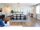 Dining area featuring a large wooden table with seating for eight and wood flooring at 8186 Guadiano Ave, Las Vegas, NV 89113