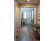 Bright entryway with wood flooring, a white front door and a staircase with wood trim at 8186 Guadiano Ave, Las Vegas, NV 89113