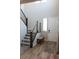 Bright entryway with wood flooring, a white front door and a staircase with wood trim at 8186 Guadiano Ave, Las Vegas, NV 89113