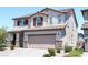 Two-story home featuring a desert landscaped yard, a two-car garage, and a classic red-tile roof at 8186 Guadiano Ave, Las Vegas, NV 89113