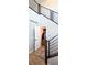 Hallway with modern railings leading up the stairs, featuring a view of an open closet at 8186 Guadiano Ave, Las Vegas, NV 89113