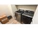 Laundry room featuring modern washer and dryer with wooden-style vinyl floors at 8186 Guadiano Ave, Las Vegas, NV 89113