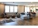 Open-concept living room with lots of windows, lots of seating, and wood flooring at 8186 Guadiano Ave, Las Vegas, NV 89113