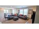 Comfortable living room featuring stylish sofas, vibrant pillows, and bright natural light at 8186 Guadiano Ave, Las Vegas, NV 89113