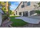 Beautifully landscaped backyard with an artificial lawn and patio at 8416 Kawala Dr, Las Vegas, NV 89128