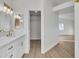 Bathroom with a white vanity, large mirror, and walk-in closet at 8416 Kawala Dr, Las Vegas, NV 89128